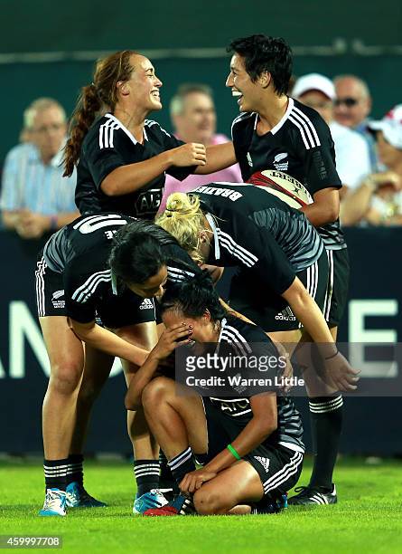 The New Zealand team celebrate beating Australia to win the IRB Women's Sevens World Series Cup Final on December 5, 2014 in Dubai, United Arab...