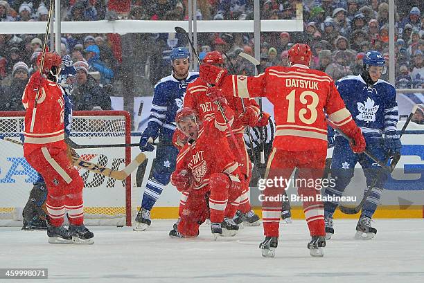 Justin Abdelkader of the Detroit Red Wings celebrates his game-tying goal as Tyler Bozak of the Toronto Maple Leafs looks on in the third period...