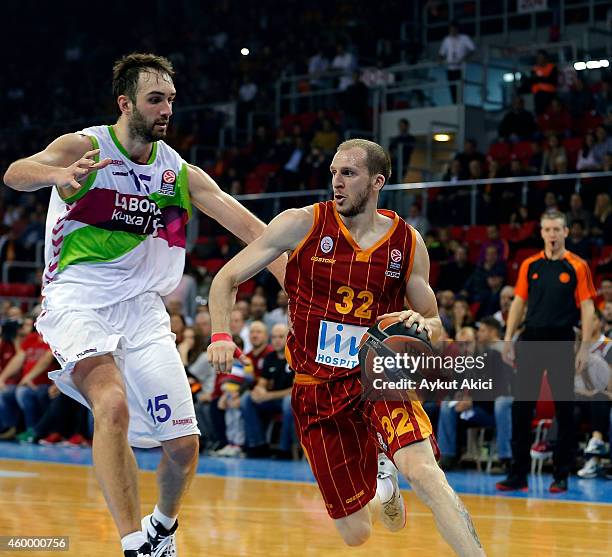 Sinan Guler, #32 of Galatasaray Liv Hospital Istanbul competes with Mirza Begic, #15 of Laboral Kutxa Vitoria during the 2014-2015 Turkish Airlines...