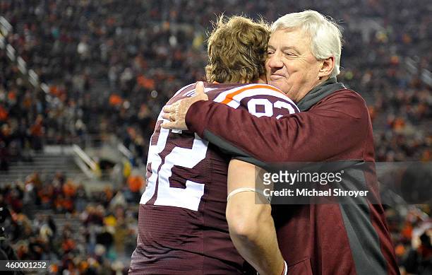 Head coach Frank Beamer greets wide receiver Willie Byrn of the Virginia Tech Hokies during the senior ceremony before the game against the Virginia...