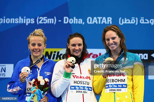 Siobhan-Marie O'Conner of Great Britain, Katinka Hosszu of Hungary and Emily Seebohm of Australia celebrates on the podium after the Women's 100m...