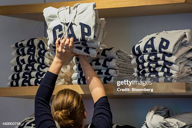 Customer browses sweatshirts at a Gap Inc. Store in San Francisco, California, U.S., on Friday, Dec. 5, 2014. Gap Inc. Reported that November 2014...