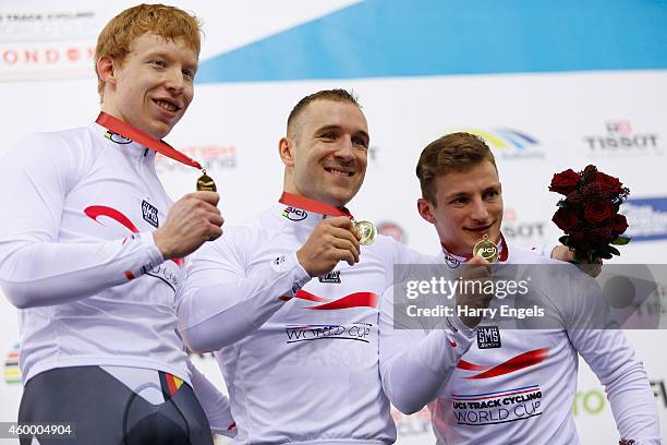 Joachim Eilers, Robert Forstemann and Rene Enders of Germany celebrate after winning the Men's Team Sprint final on day one of the UCI Track Cycling...