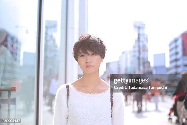 woman standing on the street - 前髪 ストックフォトと画像