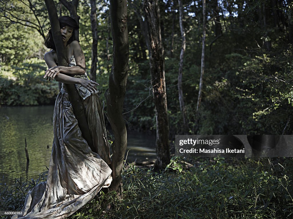 Woman wearing a long dress in the woods