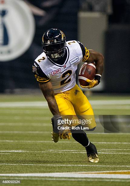 Nic Grigsby of the Hamilton Tiger-Cats runs with the ball during the 102nd Grey Cup Championship Game against the Calgary Stampeders at BC Place...