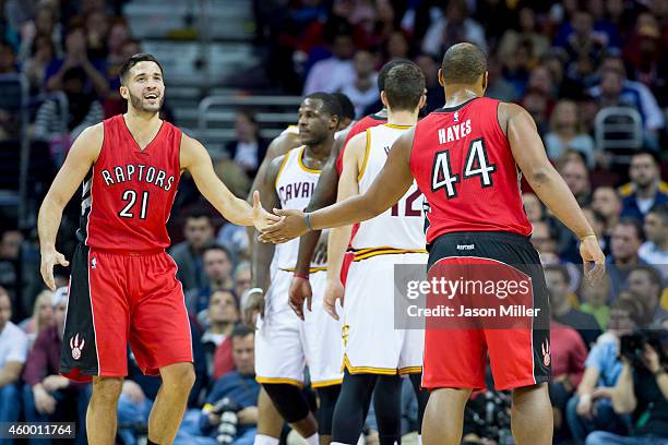 Greivis Vasquez and Chuck Hayes of the Toronto Raptors celebrate after a play during the first against the Cleveland Cavaliers half at Quicken Loans...