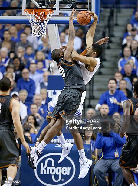 Karl-Anthony Towns of the Kentucky Wildcats shoots the ball while defended by Jonathan Holmes of the Texas Longhorns at Rupp Arena on December 5,...