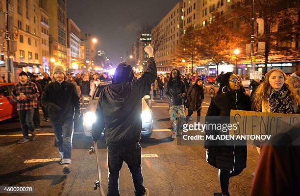Protesters march disrupting the traffic in downtown Washington DC on December 05, 2014 during the third night of nationwide protests, after a grand...