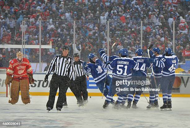 Tyler Bozak of the Toronto Maple Leafs celebrates with his teammates after scoring on goaltender Jimmy Howard of the Detroit Red Wings during...