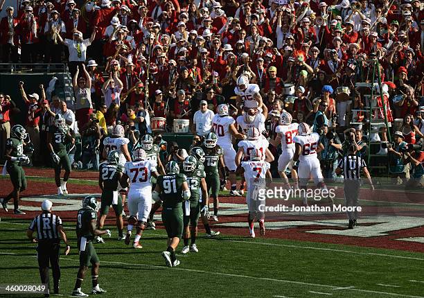 The Stanford Cardinal celebrate a touchdown by running back Tyler Gaffney on a 16-yard run against the Michigan State Spartans in the first quarter...