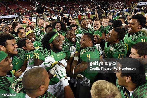 Torrodney Prevot of the Oregon Ducks, center, and Erick Dargan of the Oregon Ducks, center right, celebrate their PAC-12 victory against the Arizona...