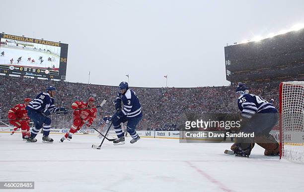 Dion Phaneuf of the Toronto Maple Leafs controls the puck in the low slot area as Daniel Cleary of the Detroit Red Wings pursues the play in the...