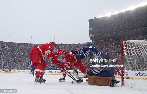 Goaltender Jonathan Bernier and Cody Franson of the Toronto Maple Leafs defend the play at the net of Gustav Nyquist and Daniel Cleary of the Detroit...