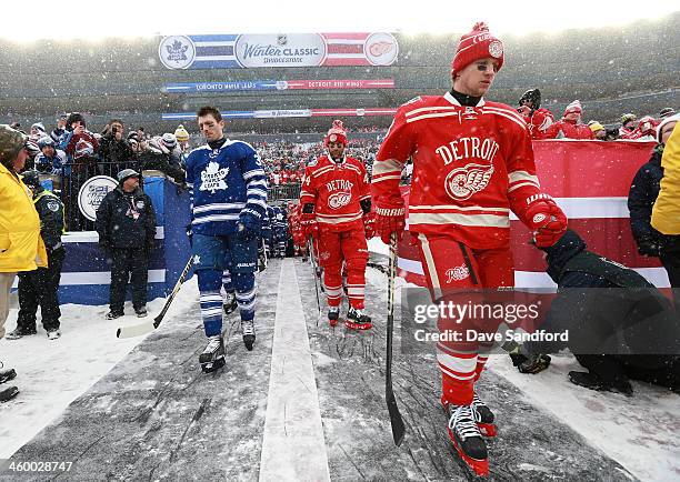 Frazer McLaren of the Toronto Maple Leafs, Todd Bertuzzi and Justin Abdelkader of the Detroit Red Wings make their way to the ice surface for warm-up...