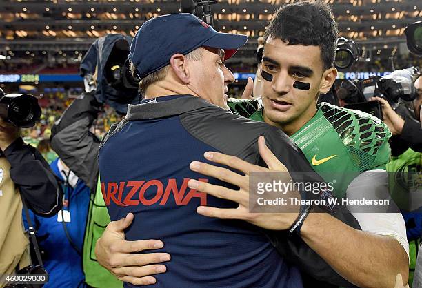 Head coach Rich Rodriguez of the Arizona Wildcats congratulates Marcus Mariota of the Oregon Ducks after the Ducks defeated the Wildcats in the...