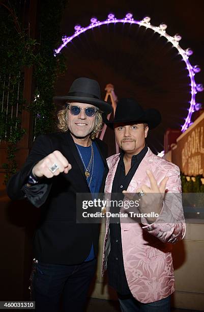 Big Kenny and John Rich of Big & Rich pose for a photo in front of The High Roller at The LINQ Promenade on December 5, 2014 in Las Vegas, Nevada.