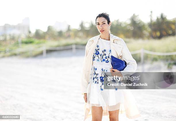 Belaxis Buil is seen outside the Scope show wearing a Banana Republic trench coat, Marc Jacobs sunglasses with a West Elm bag on December 5, 2014 in...