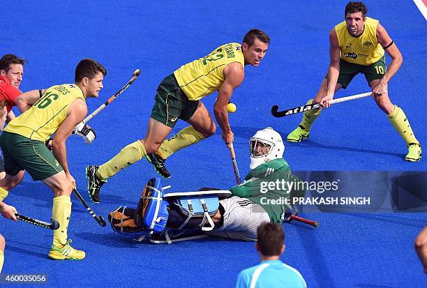 England's goal keeper George Pinner watches a shot by Australia's Matt Gohdes during their Hero Hockey Champions Trophy 2014 match at Kalinga Stadium...