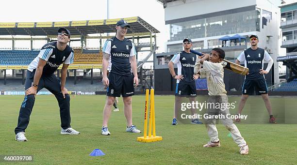 Steven Finn; Ben Stokes, Ian Bell and Alex Hales of England coach local children during a charity event at R. Premadasa Stadium on December 6, 2014...