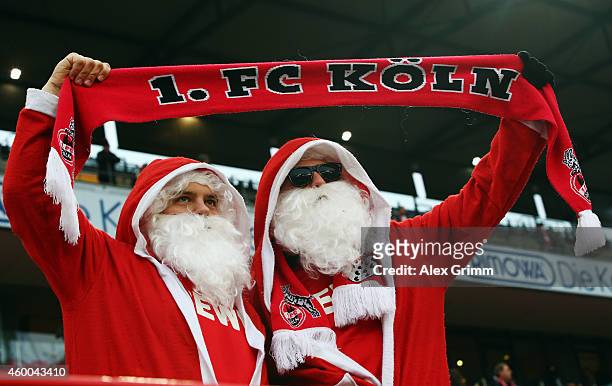 Two fans of Koeln wear Santa Claus dresses during the Bundesliga match between 1. FC Koeln and FC Augsburg at RheinEnergieStadion on December 6, 2014...