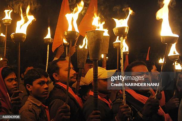 Indian activists of the Hindu Bajrang Dal Party hold torches during a procession marking the 22nd anniversary of the demolition of the Babri Masjid...