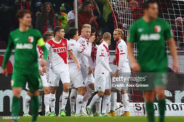 Anthony Ujah of Koeln celebrates his team's first goal with team mates during the Bundesliga match between 1. FC Koeln and FC Augsburg at...