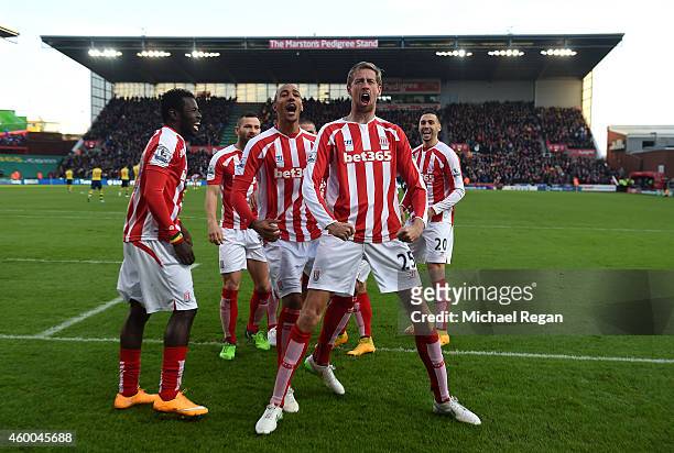 Peter Crouch of Stoke City celebrates scoring the opening goal with his team-mates during the Barclays Premier League match between Stoke City and...
