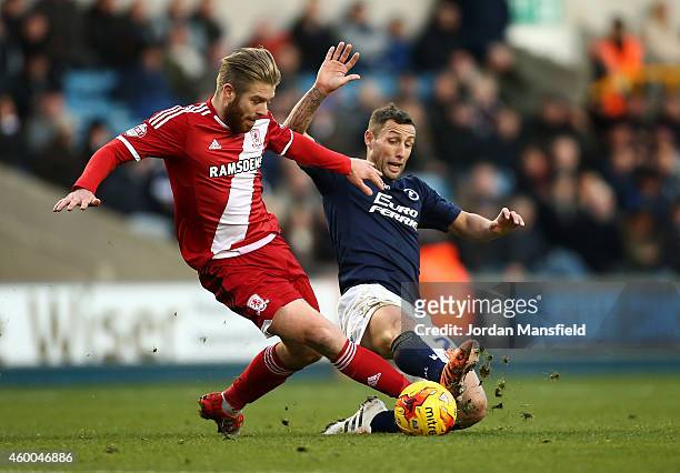 Adam Clayton of Middlesbrough tackles Scott McDonald of Millwall during the Sky Bet Championship match between Millwall and Middlesbrough at The Den...