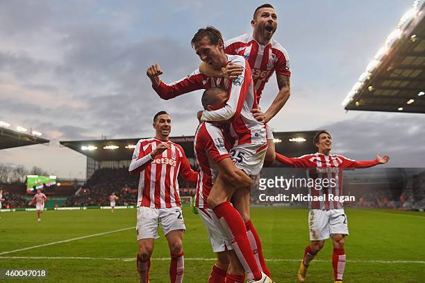 Jon Walters of Stoke is mobed by Phil Bardsley and Peter Crouch after scoring to make it 3-0 during the Barclays Premier League match between Stoke...