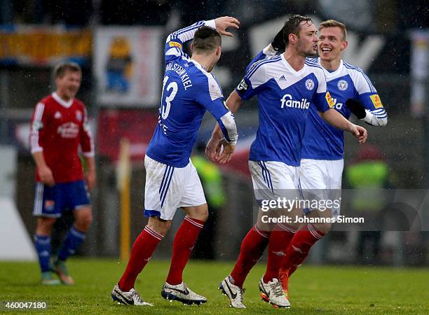 Patrick Breitkreuz of Kiel celebrates with team mates Marlon Krause and Maik Kegel after scoring his team's first goal during the Third League match...