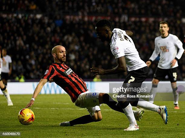 Simon Dawkins of Derby is challenged by Bruno Saltor of Brighton during the Sky Bet Championship match between Derby County and Brighton & Hove...