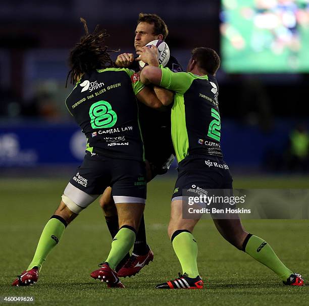 Andrew Fenby of London Irish is tackled by Josh Navidi and Matthew Rees of Cardiff during the European Rugby Challenge Cup match between Cardiff...