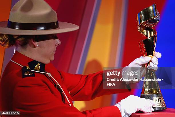 The FIFA Woman`s World Cup Trophy is carried by a Officers of the Royal Canadian Mounted Police during the Final Draw for the FIFA Women's World Cup...