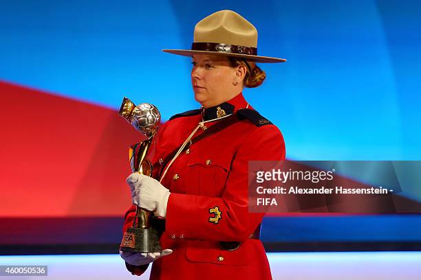 The FIFA Woman`s World Cup Trophy is carried by a Officers of the Royal Canadian Mounted Police during the Final Draw for the FIFA Women's World Cup...