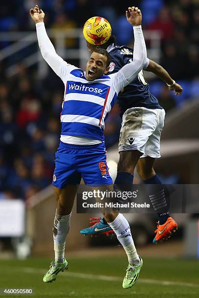 Hal Robson-Kanu of Reading feels a challenge from Neil Danns of Bolton Wanderers during the Sky Bet Championship match between Reading and Bolton...