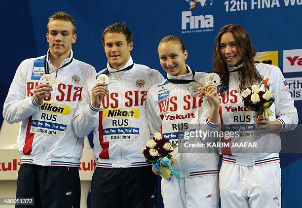 Evgeny Sedov, Vladimir Morozov, Veronika Popova and Rozaliya Nasretdinova of team Russia, pose with their silver medals after the final of the Mixed...