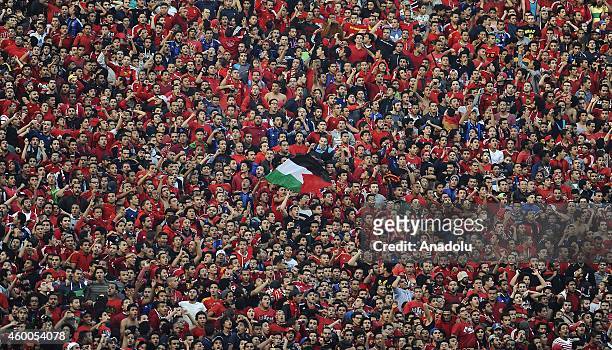 Fans of the Egypt's Al-Ahly chant slogans before the second leg of the CAF Confederation Cup final football match between Egypt's Al-Ahly and Ivory...