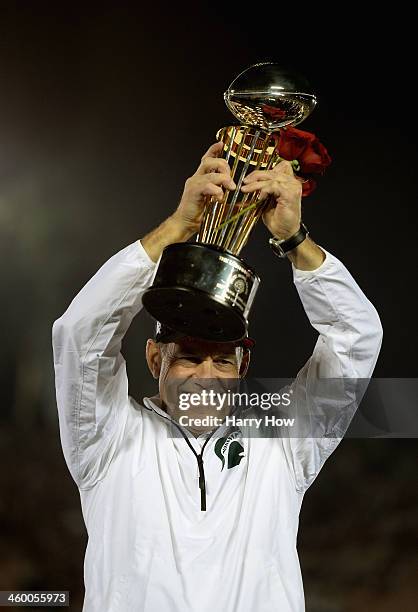 Michigan State Spartans head coach Mark Dantonio celebrates with the Rose Bowl Game trophy after defeating the Stanford Cardinal 24-20 in the 100th...