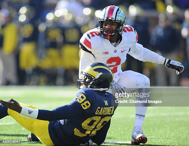 Quarterback Devin Gardner of the Michigan Wolverines picks himself up off the ground after being knocked down by linebacker Ryan Shazier during a...