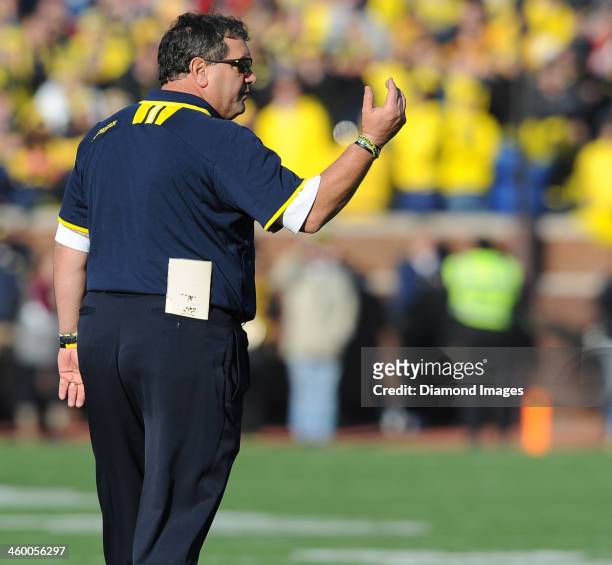 Head coach Brady Hoke of the Michigan Wolverines calls a player to the sideline during a game against the Ohio State Buckeyes at Michigan Stadium in...