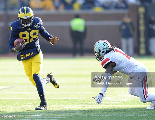 Quarterback Devin Gardner of the Michigan Wolverines runs the football during a game against the Ohio State Buckeyes at Michigan Stadium in Ann...