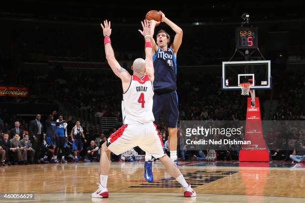 Dirk Nowitzki of the Dallas Mavericks shoots against Marcin Gortat of the Washington Wizards during the game at the Verizon Center on January 1, 2014...