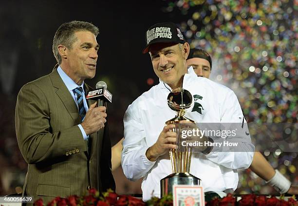 Michigan State Spartans head coach Mark Dantonio is presented the Rose Bowl Game trophy by ESPN's Chris Fowler after defeating the Stanford Cardinal...