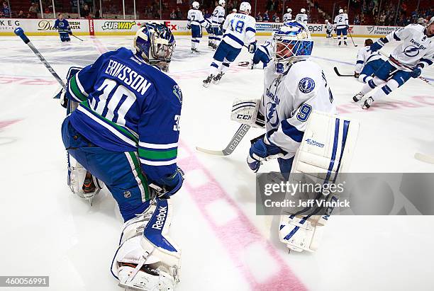 Swedish goaltenders Joacim Eriksson of the Vancouver Canucks and Anders Lindback of the Tampa Bay Lightning chat before their NHL game at Rogers...