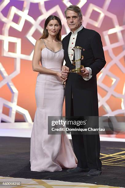 Laetitia Casta presents Jeremy Irons with a tribute award during the Evening Tribute To Jeremy Irons as part of the 14th Marrakech International Film...
