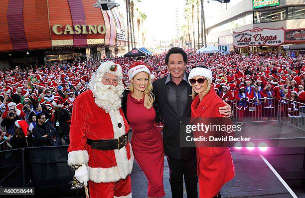 Santa Claus character, model and television personality Holly Madison, entertainers Wayne Newton and Olivia Newton-John appear at the 10th annual Las...