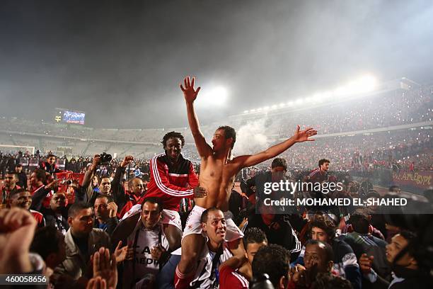 Egypt's Al-Ahly Walid Soliman and Moussa Yedan are paraded by fans after winning the CAF Confederation Cup final football match between Egypt's...