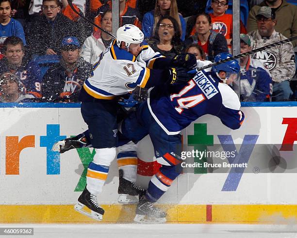 Thomas Hickey of the New York Islanders is hit by Jaden Schwartz of the St. Louis Blues during the second period at the Nassau Veterans Memorial...