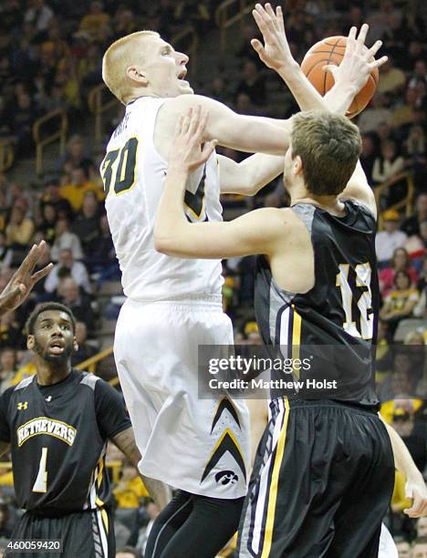 Forward Aaron White of the Iowa Hawkeyes drives to the basket against guard Will Darley of the UMBC Retrievers, in the first half on December 6, 2014...